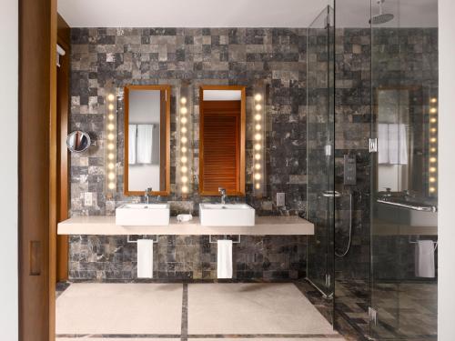 a bathroom with two sinks and a shower at Villa Nautica Paradise Island Resort in North Male Atoll