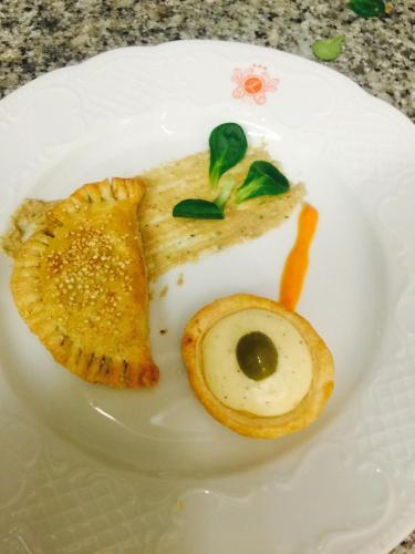 a white plate with a piece of food on it at Lolli Palace Hotel in Sanremo