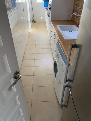 a kitchen with a washing machine and a sink at Campoamor Villa & Private Pool, Garden & Roof Terraces Distant Sea Views in Playas de Orihuela