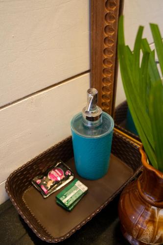 a blue container sitting on a tray next to a mirror at Shambho Retreat in Canacona