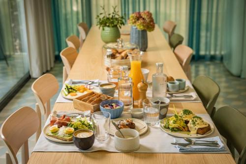 a long table with plates of food on it at Bagatelle Gardenhouse in Budapest