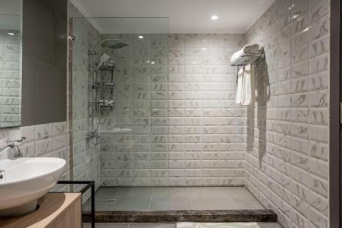 a bathroom with a sink and a shower at Brassbell apartments in Giza in Cairo