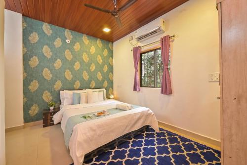 a bedroom with a large bed and a window at Infinity Pool 2bhk Villa with valley view in Panchgani