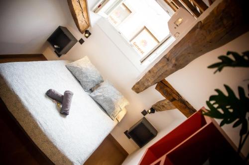an overhead view of a bed with a remote control on it at Onefam Sungate in Madrid