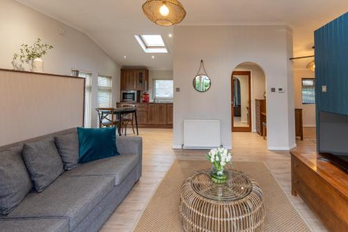 a living room with a couch and a table at Ribblesdale Park in Gisburn