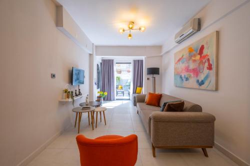 a living room with a couch and a table at Ezgi's Apartment with Private Garden in Marmaris in Marmaris