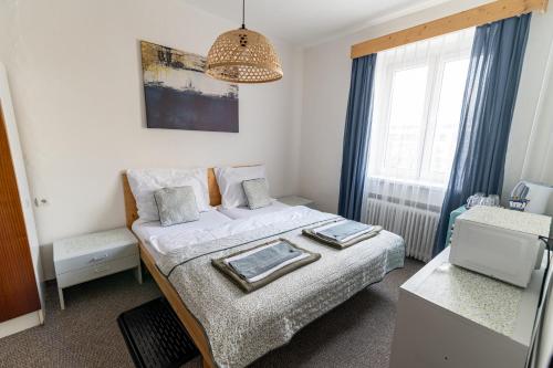 a small bedroom with a bed and a window at Turistická ubytovňa in Liptovský Mikuláš