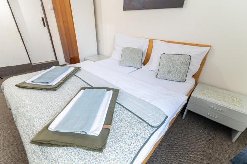 a bed with two pillows and a tray on it at Turistická ubytovňa in Liptovský Mikuláš