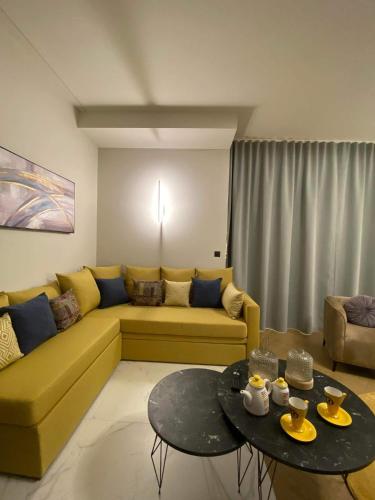 a living room with a yellow couch and a table at Luxury Villas Chrysa Private Pool & Spa in Nafplio