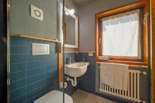 a bathroom with a sink and a toilet and a window at Petit Bleu in Chamois