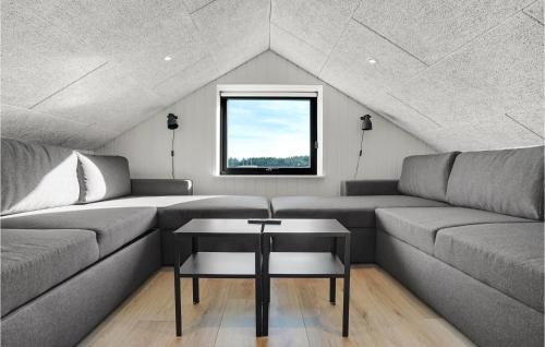 a living room with a couch and a table at Beautiful Home In Thisted With Sauna in Thisted