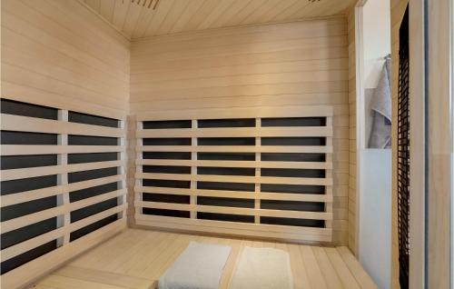 a sauna with wooden walls and a wooden floor at Beautiful Home In Thisted With Sauna in Thisted