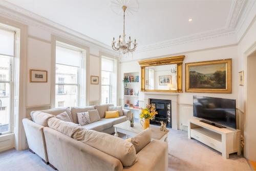 a living room with a couch and a television at Tylney House in Bath