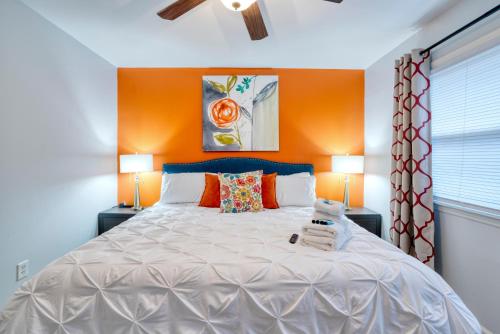 a bedroom with a large white bed with two lamps at Trendy Escape ◉ California King bed awaits! in Charlotte