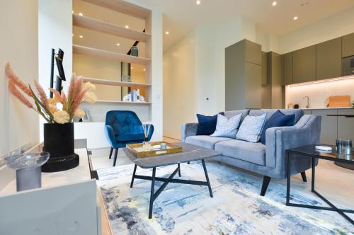 a living room with a couch and a table at Haverstock Hill Serviced Apartments by Concept Apartments in London