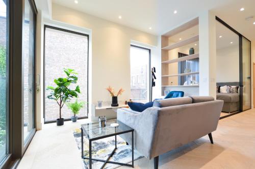 a living room with a couch and a table at Haverstock Hill Serviced Apartments by Concept Apartments in London