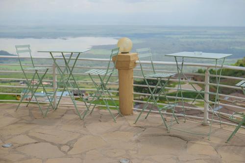 a group of chairs and tables and a microphone at Lake Elementaita Mountain Lodge in Nakuru