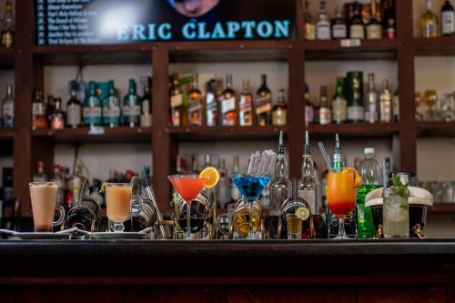 a bar with a bunch of glasses on a counter at Lake Elementaita Mountain Lodge in Nakuru