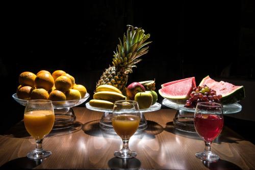 a table topped with bowls of fruit and wine glasses at Korai Suites by Good Life in Heraklio Town