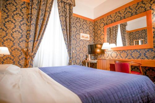 Säng eller sängar i ett rum på LH Hotel Andreotti