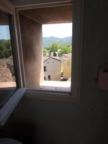 a window in a room with a view of a building at Verdon Secret - L'escapade parfaite in Gréoux-les-Bains