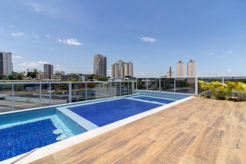 a swimming pool on the roof of a building at Contemporary Studio - GRU in Guarulhos