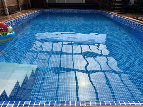 a swimming pool with a painting of polar bears on it at Arbel Holiday Homes in Arbel