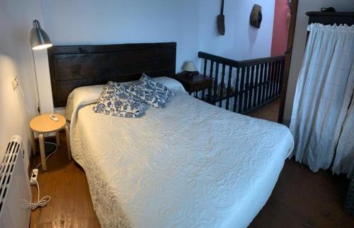 a bedroom with a bed with a blue comforter at La Forna in Caso