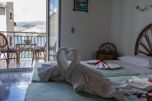 a swan made out of towels sitting on two beds at Marina Studios I in Argostoli