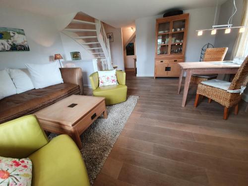 a living room with a couch and a table at Hotel Duene in Rantum