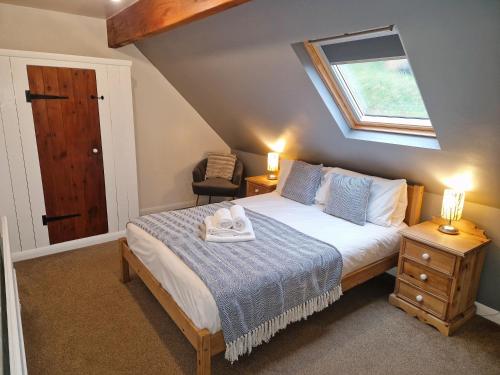 sypialnia z łóżkiem i świetlikiem w obiekcie Ash Cottage w mieście Hope