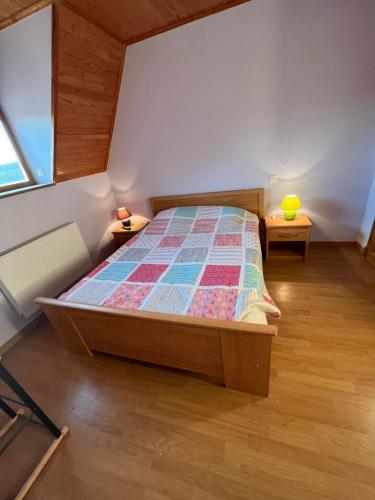 a bedroom with a bed with a quilt on it at chambre d'hote in Marcilhac-sur-Célé