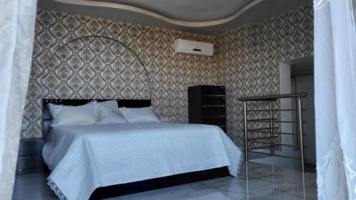a bedroom with a bed and a wall at Villa Ventsislava in Metókhion Konstamonítou