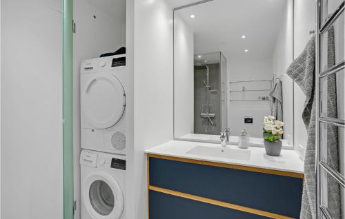 a bathroom with a sink and a washing machine at Light House in Aarhus