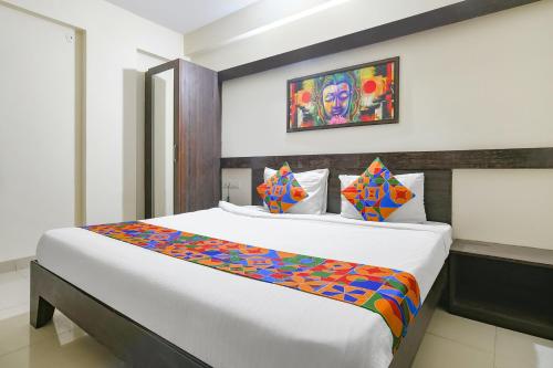 a bedroom with a large bed in a room at FabExpress Golden Villa in Indore
