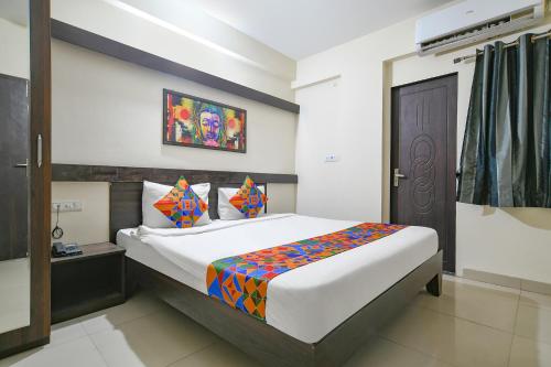 a bedroom with a large bed in a room at FabExpress Golden Villa in Indore