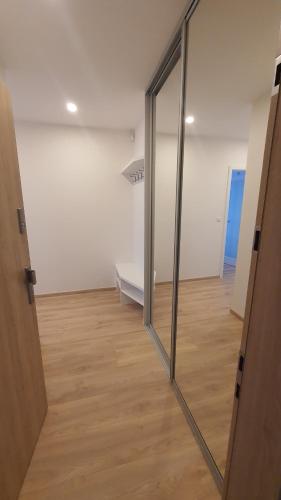 a sliding glass door leading into an empty room at Apartmány Semily in Semily
