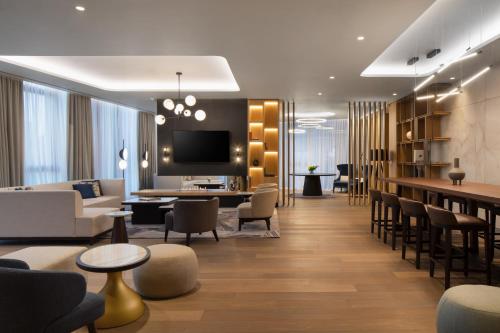 a hotel lobby with a bar and a living room at Tirana Marriott Hotel in Tirana