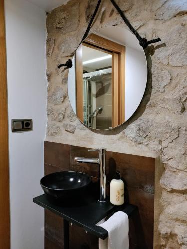 a bathroom with a sink and a mirror at Casa al lado del mar in Vilagarcia de Arousa