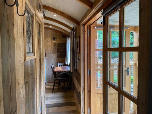 a hallway of a tiny house with a dining room at The Walnut Wagon in the heart of Mells. in Frome