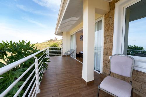 a balcony with a view of the ocean at Lake Elementaita Mountain Lodge in Nakuru