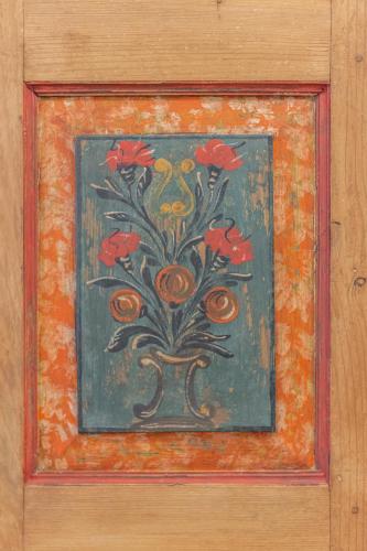 a painting of a plant with red flowers on a wall at DolomiApartments - Appartamenti Campanil 1 e Campanil 2 in Predazzo