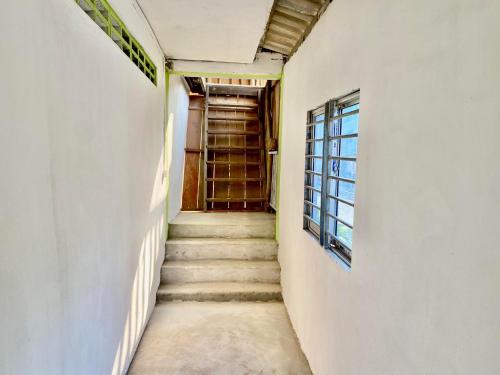 a hallway with stairs leading to a door at Happiness Guesthouse in Koh Rong Sanloem