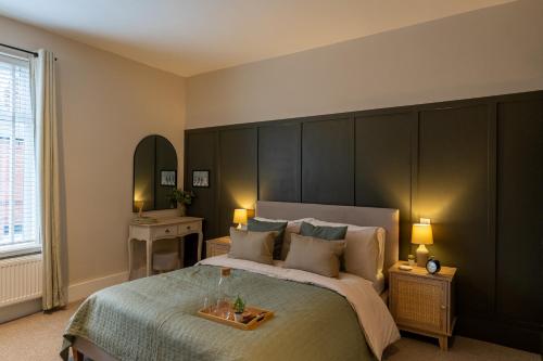 a bedroom with a large bed with a large headboard at The Willows in Newton-le-Willows