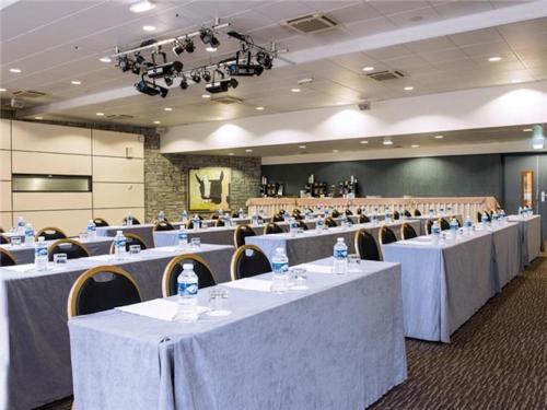 a large room with tables and chairs with white table cloth at La Villa Du Lac- 3 rooms for 6 people in Divonne-les-Bains