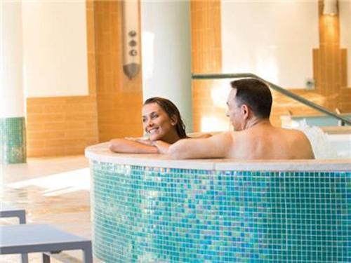 a man and a woman sitting in a bath tub at La Villa Du Lac- 3 rooms for 6 people in Divonne-les-Bains