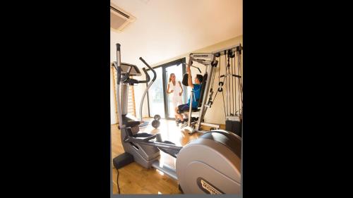 a gym with two people working out in the gym at La Villa Du Lac- 3 rooms for 6 people in Divonne-les-Bains