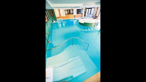 a swimming pool with a slide in the middle at La Villa Du Lac- 3 rooms for 6 people in Divonne-les-Bains