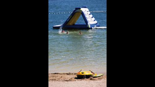a slide in the water at a beach at La Villa Du Lac- 3 rooms for 6 people in Divonne-les-Bains