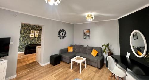 a living room with a couch and a table at Apartamenty Katowicka 38 in Świętochłowice